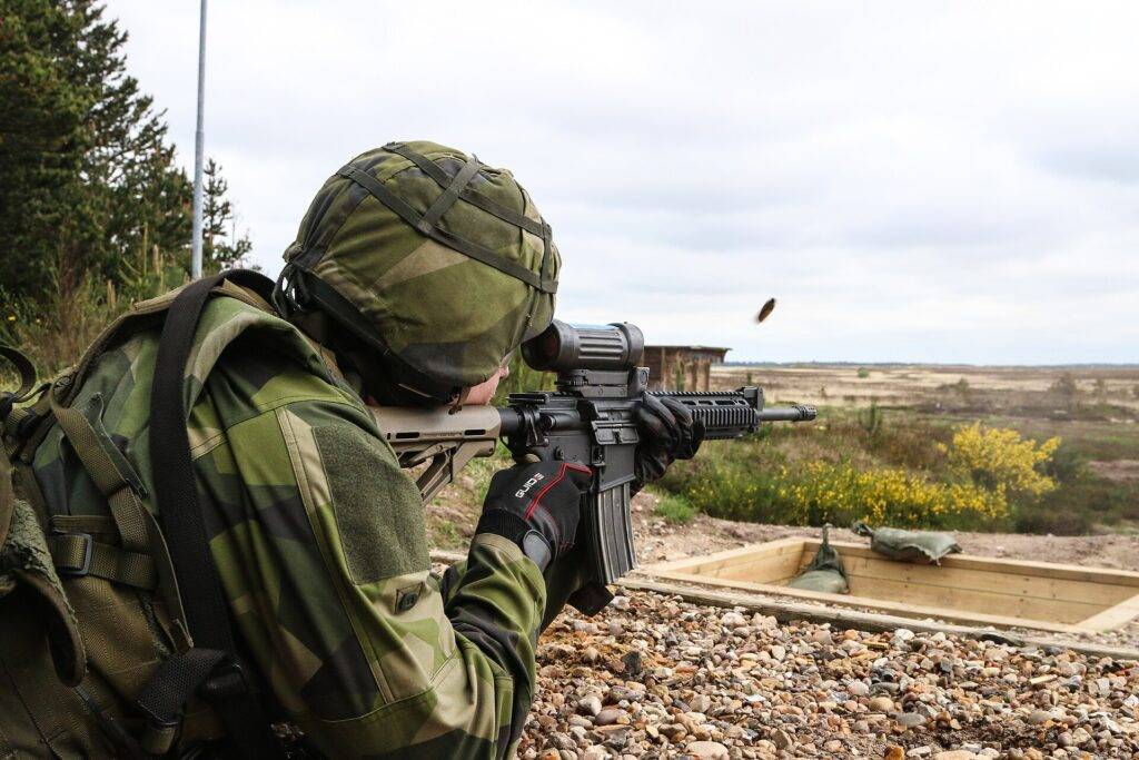 First Sergeant Manttias Larsson of the Swedish army's Norrbotten Regiment, fires a Colt Canada C8 carbine rifle at targets during the Nordic Tank Challenge in Holstebro, Denmark, May 23, 2016. Throughout the competition, participating tank crews were graded on their abilities to perform first aid, tank maintenance, maneuvering and firing, and marksmanship. (U.S. Army photo by Staff Sgt. Michael Behlin)