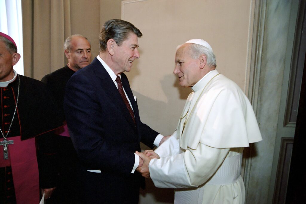 US President Ronald Reagan meeting with Pope John Paul II during a visit to the Vatican City, 1982 (Image:  Reagan White House Photographs, 1/20/1981 - 1/20/1989Collection: White House Photographic Collection, 1/20/1981 - 1/20/1989 - https://catalog.archives.gov/id/75856819, Public Domain, https://commons.wikimedia.org/w/index.php?curid=91230667)